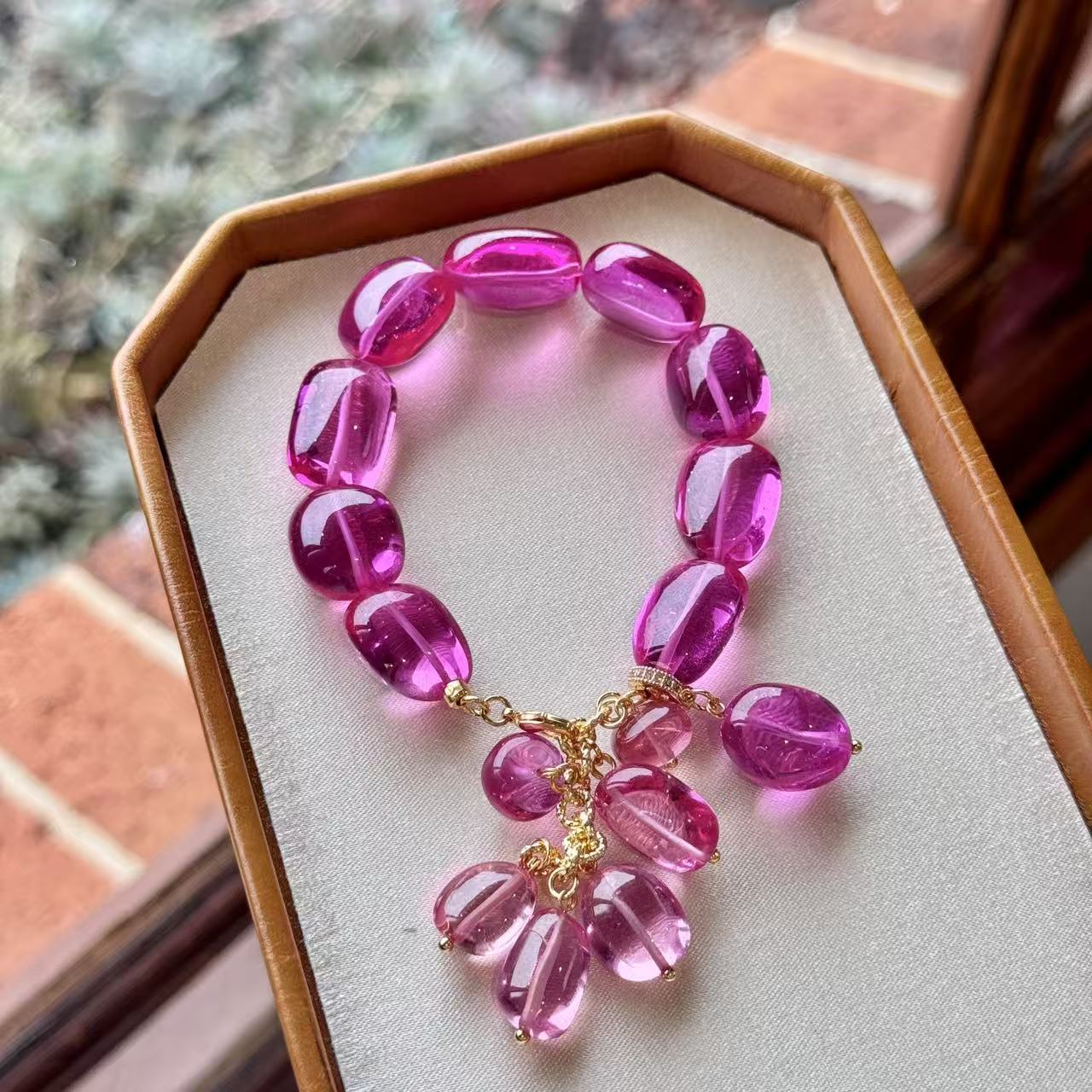 Padparadscha pink bracelet displayed in a jewelry box