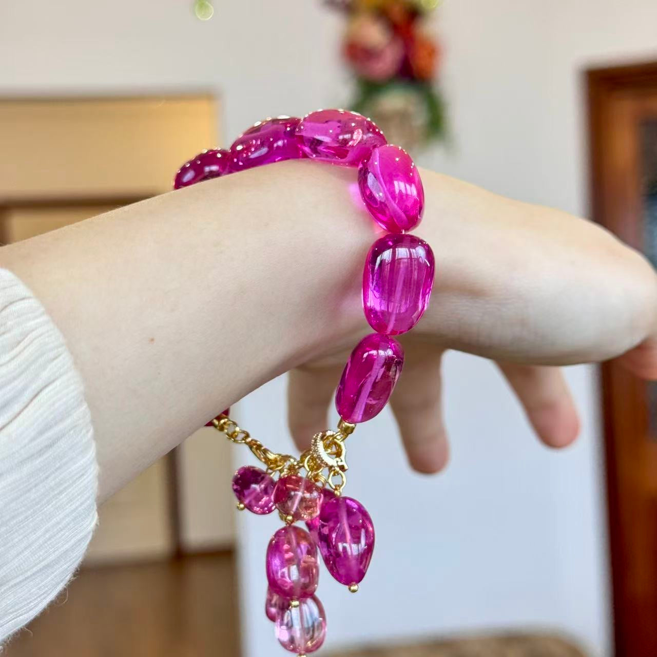 Padparadscha pink bracelet worn on wrist, side view